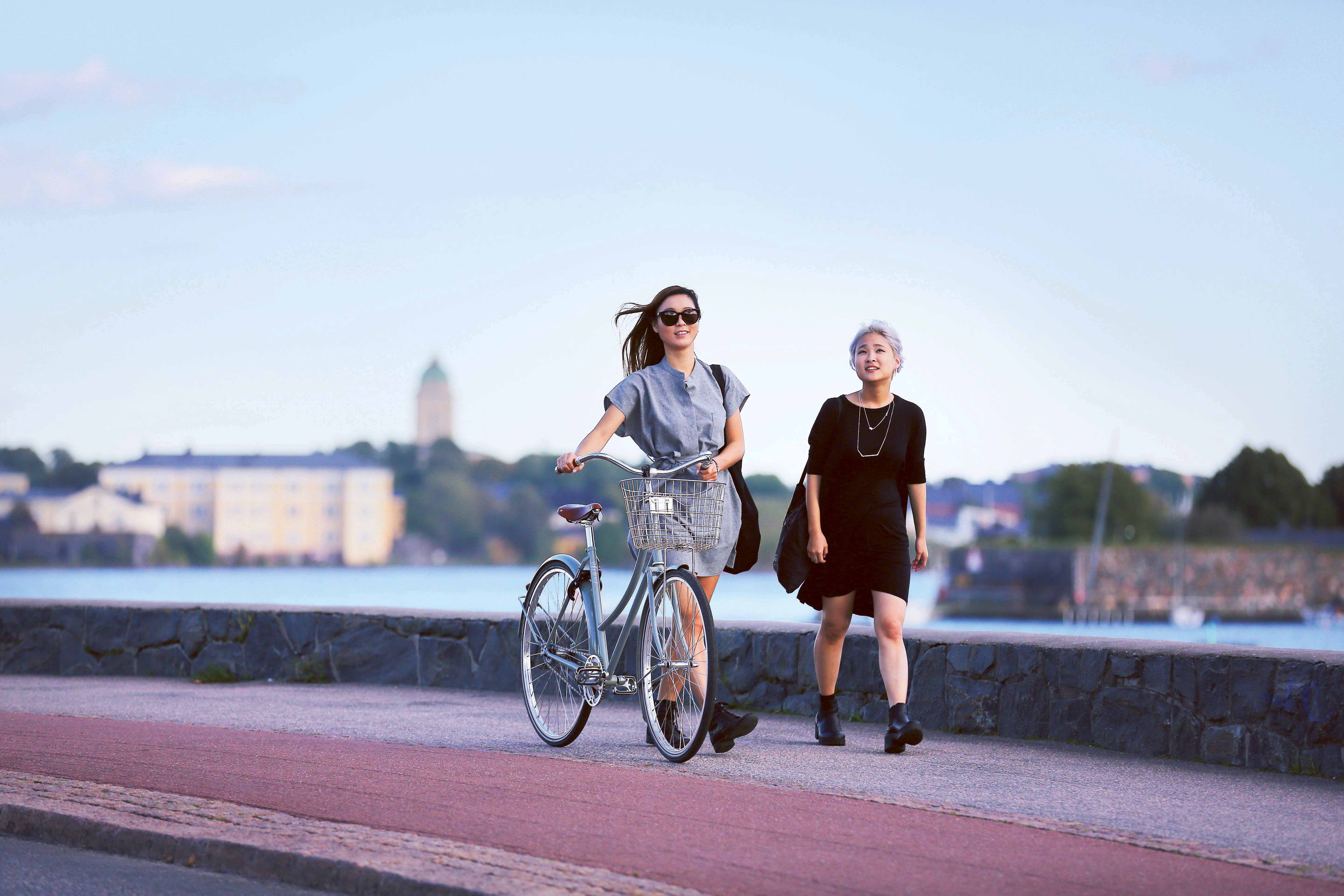 Two people walking by the Baltic sea in urban Helsinki.